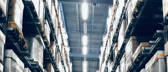 Aisle of a stocked warehouse with racked pallets